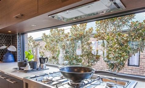 can a gas stove go under a window